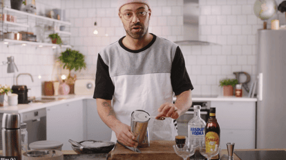 Bartender with a cocktail shaker and Hawthorne strainer
