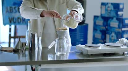Fat-washed Vodka being filtered into a Mason Jar using a Coffee Filter.