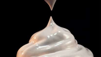 Cream siphon creating cocktail foam.