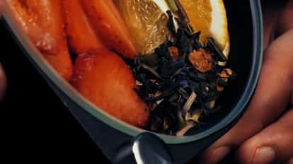 Porthole cocktail infuser loaded with citrus fruits, strawberries and herbs.
