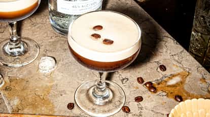 Classic Espresso Martini next to a bottle of Absolut Vodka.