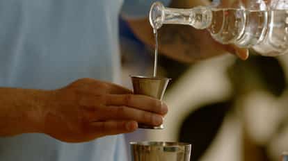 Pouring Marschino Liqueur into a cocktail shaker for a Clean Aviation
