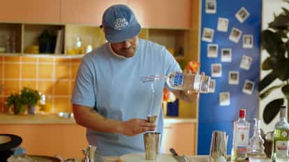 Bartender Rico pouring Absolut Vodka into a cocktail shaker