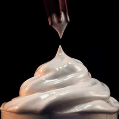 Cream siphon creating cocktail foam.