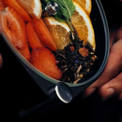 Porthole cocktail infuser loaded with citrus fruits, strawberries and herbs.