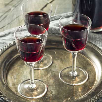 Amontillado Sherry in three stemmed glasses on a metal tray