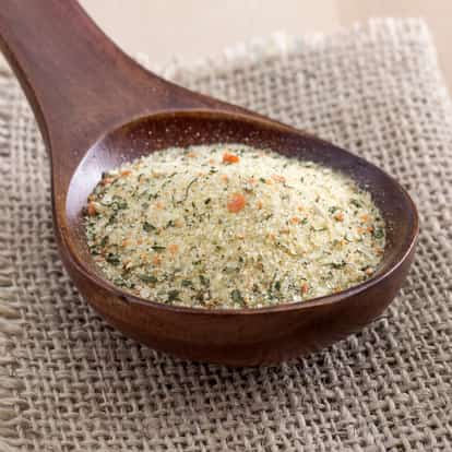 Celery Salt in a wooden spoon on burlap background