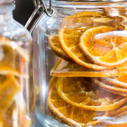 Dried lemon slices stacked inside a glass jar.