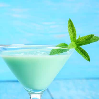 Green Curacao in a martini glass with mint sprig