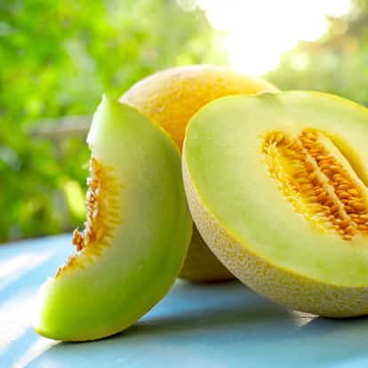 Honeydew melon halved and sliced with seeds visible
