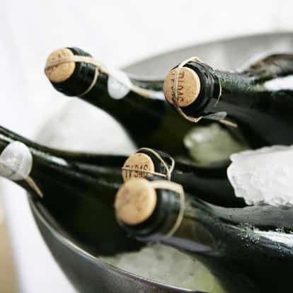 Sparkling Wine bottles in an ice bucket with corks and wire cages