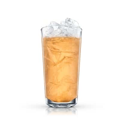 An iced amber cocktail sits in a tall highball glass filled with crushed ice on white background.