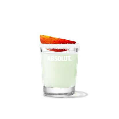 Absolut Apeach Drop in a rocks glass with sugared rim and peach wedge on white background