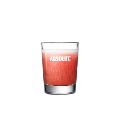 Absolut Cordial Drop in a rocks glass with foam on white background