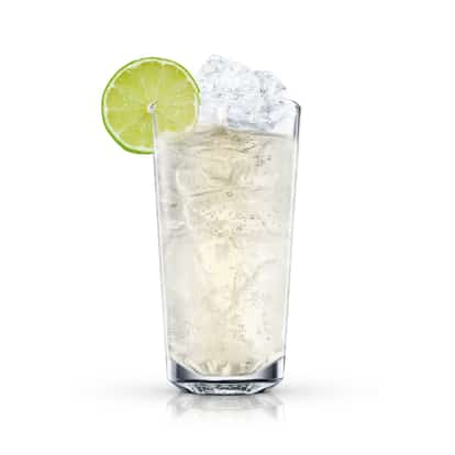 Absolut Jamaican Mule served in a highball glass with ice and lime wheel on white background