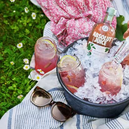 Absolut Juice Rhubarb and Soda in mason jars with lemon slices served in an ice-filled bucket.