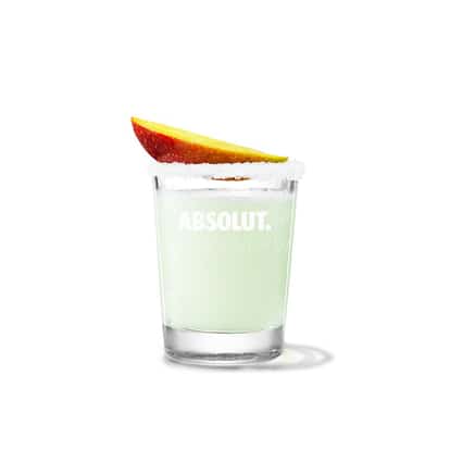 Absolut Mango Drop in a rocks glass with sugar rim and mango wedge on white background