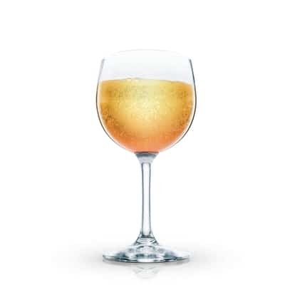 Sparkling peach cocktail in a stemmed wine glass on white background.