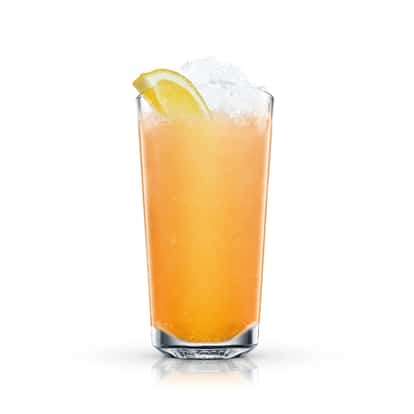 Absolut Pears Mango in a highball glass topped with crushed ice and a lemon wedge on white background