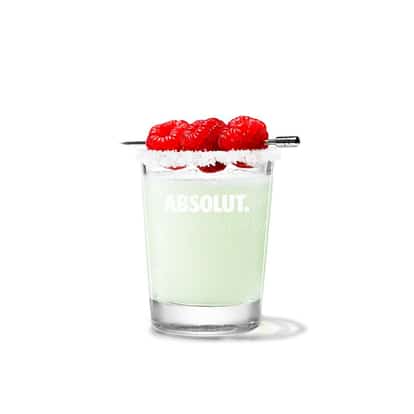 Absolut Raspberri Drop in a rocks glass with sugared rim and three raspberries on a skewer on white background