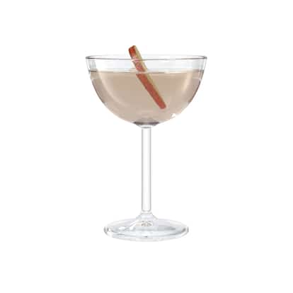 Adam y Eva in a coupe glass with an apple peel garnish on white background