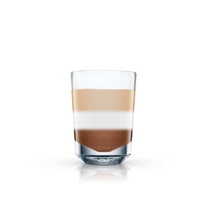After Six layered in a shot glass with three distinct layers and reflection on white background
