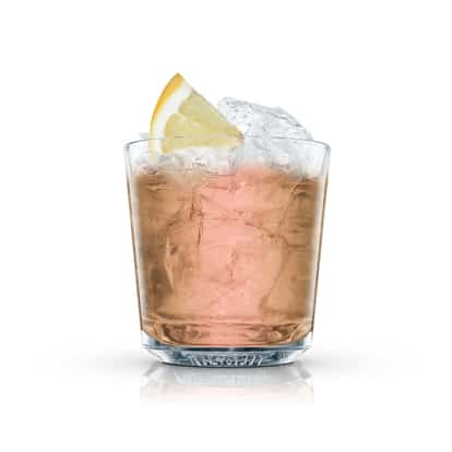 Alma in an Absolut rocks glass with crushed ice and a lemon wedge on white background