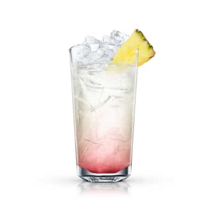 Amber Glow in a highball glass with crushed ice and pineapple wedge on the rim on white background