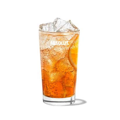 Americano served in an Absolut highball glass with ice and orange slice