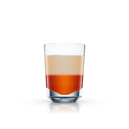 Angel Face layered cocktail in a clear shot glass on white background.
