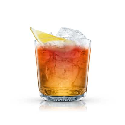 Apple Dubonnet in an Absolut rocks glass with ice and a lemon wedge on white background