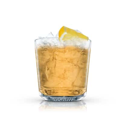 Apple Jack Sour in an Absolut rocks glass with crushed ice and lemon wedge on white background