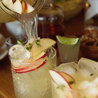Applebreeze in a rocks glass with apple slices and large ice cubes