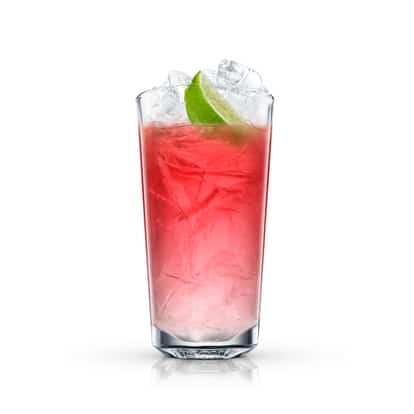 Arizona Cooler in a highball glass with crushed ice and a lime wedge on white background