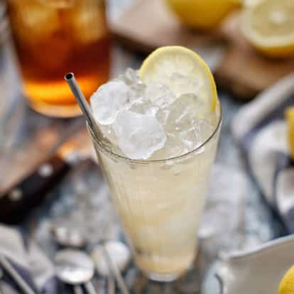 Classic Arnold Palmer drink made with Iced Tea and Lemonade garnished with a Lemon Wheel.