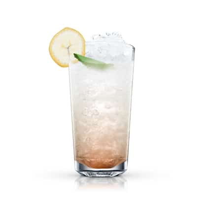 Banana Punch in a highball glass filled with crushed ice and garnished with a banana slice and leaf