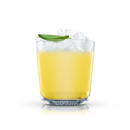 Batida served in an Absolut rocks glass with crushed ice and a mint leaf on white background.