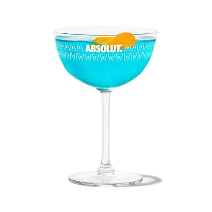 Bikini Martini in an Absolut coupe glass with an orange peel on white background
