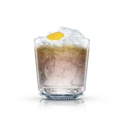 Black Magic in an Absolut rocks glass with crushed ice and lemon peel on white background