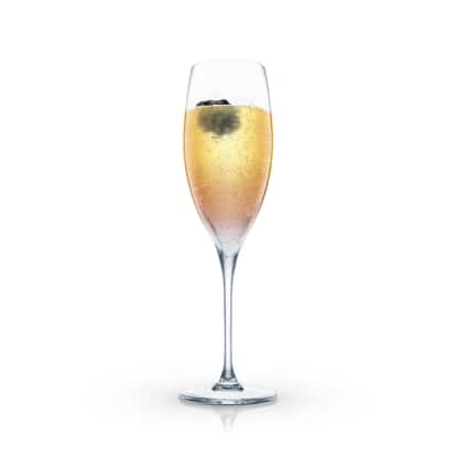Blackberry Bellini in a champagne flute with a blackberry garnish on white background