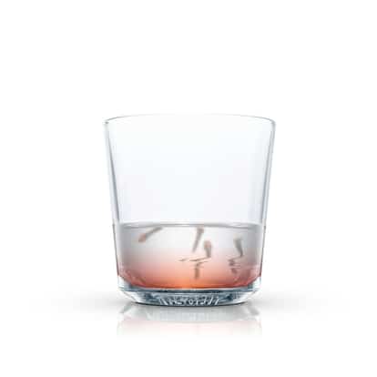 Brandy Toddy in an Absolut rocks glass with a small amount of liquid on white background
