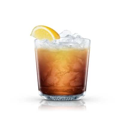 Brown cocktail with crushed ice and lemon wedge in an Absolut rocks glass on white background.