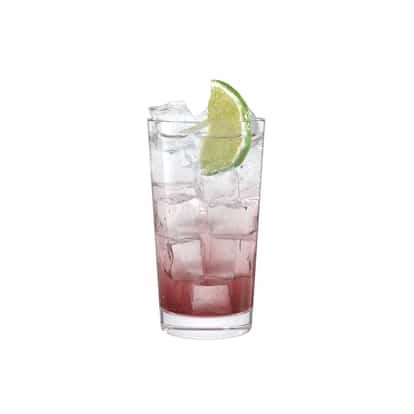 Campari Soda in a highball glass with ice and a lime wedge on white background