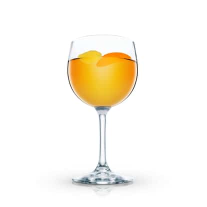 Cinnamon Warmer served in a stemmed wine glass with two orange peels on white background