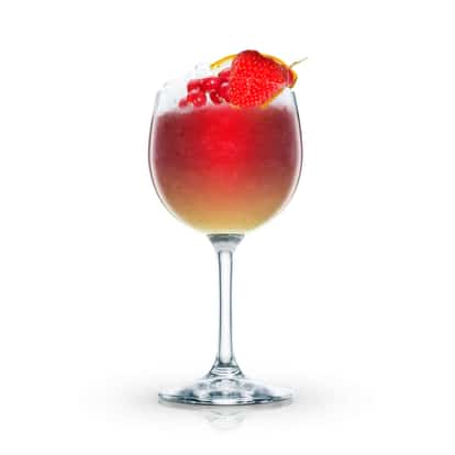 Claret Punch in a wine glass garnished with strawberry, red currants and an orange slice on white background