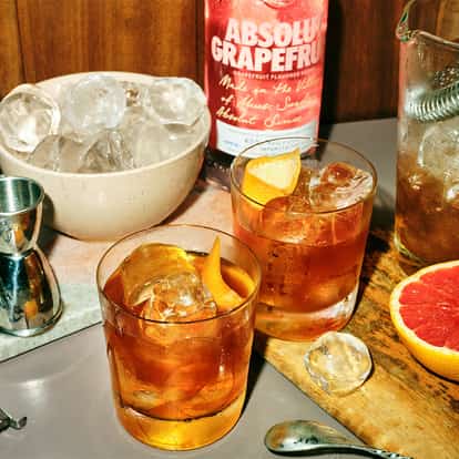 Coffee With Gianni served in two rocks glasses with large ice cubes and citrus peel and an Absolut Grapefruit bottle