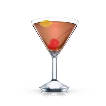 Criollo in a martini glass with a maraschino cherry and lemon peel on white background