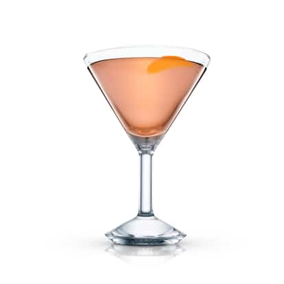 Cocktail in a martini glass with an orange peel garnish on white background