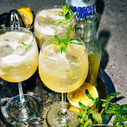 Doris Royal in iced wine glasses on a tray with mint sprigs and an Absolut Vodka bottle