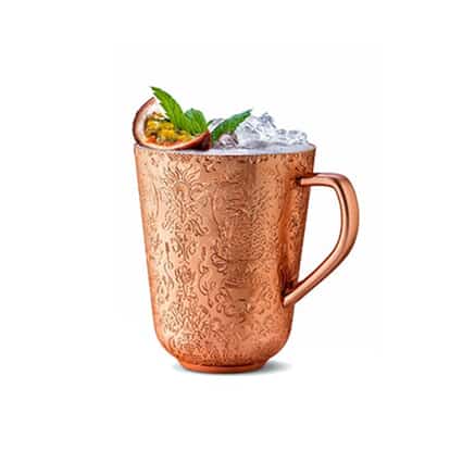Copper Cup #16 in a copper mug with crushed ice, halved passionfruit and mint sprig on white background